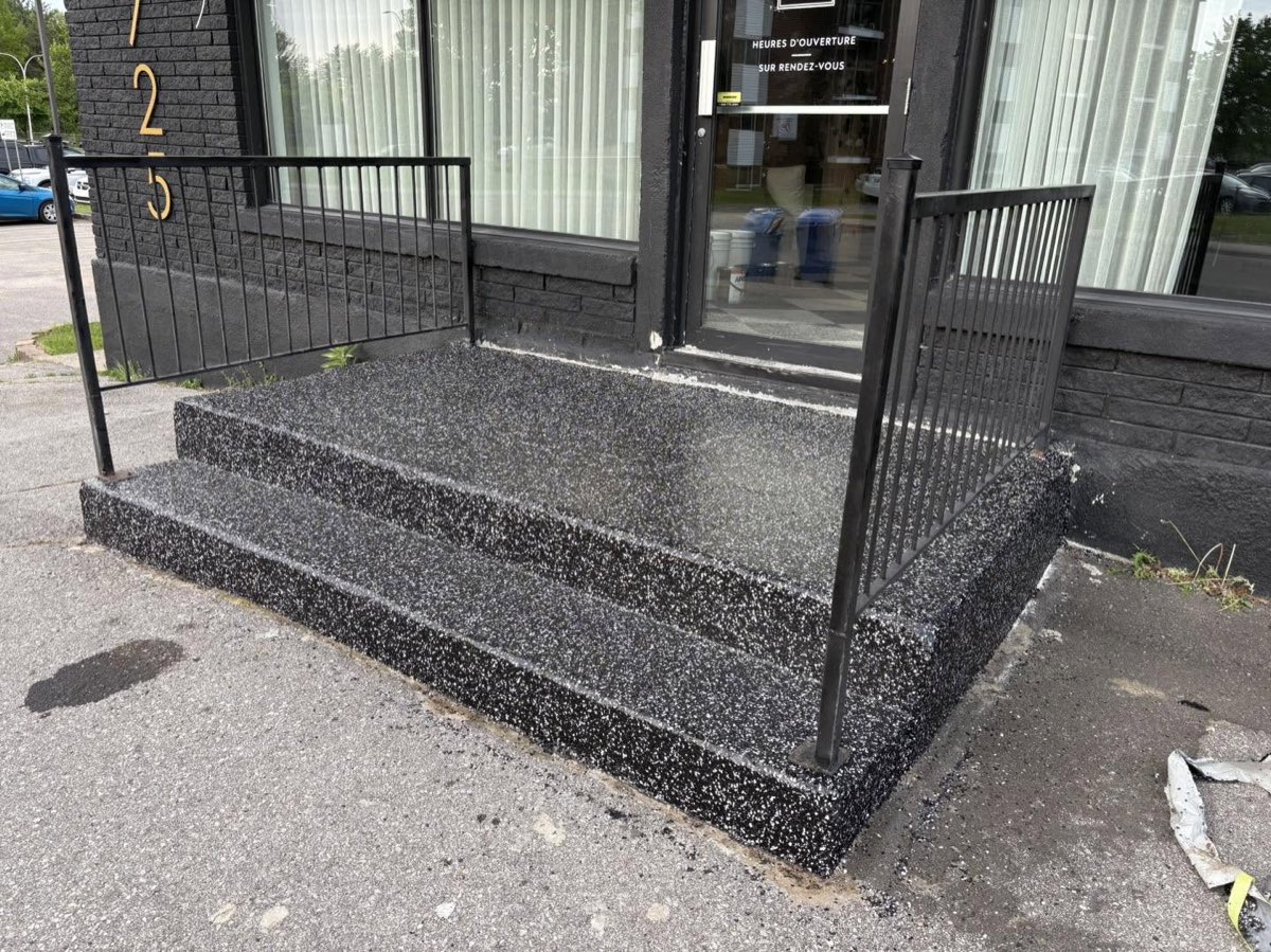 Escalier d'entrée commerciale après travaux, fini noir à flocons sur les marches et le palier